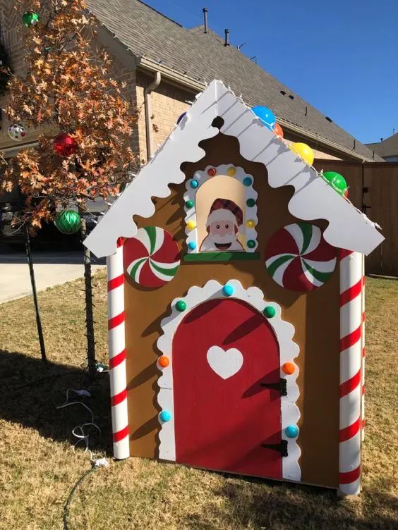 a house made out of cardboard and decorated like a gingerbread house with candy canes