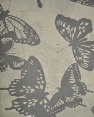 the butterflies are flying in the air on the sheeted bed spreader, which is covered with black and white butterfly print