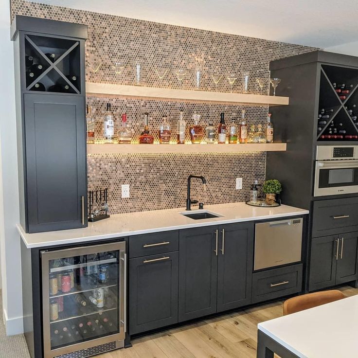 a kitchen with an oven, sink and wine rack