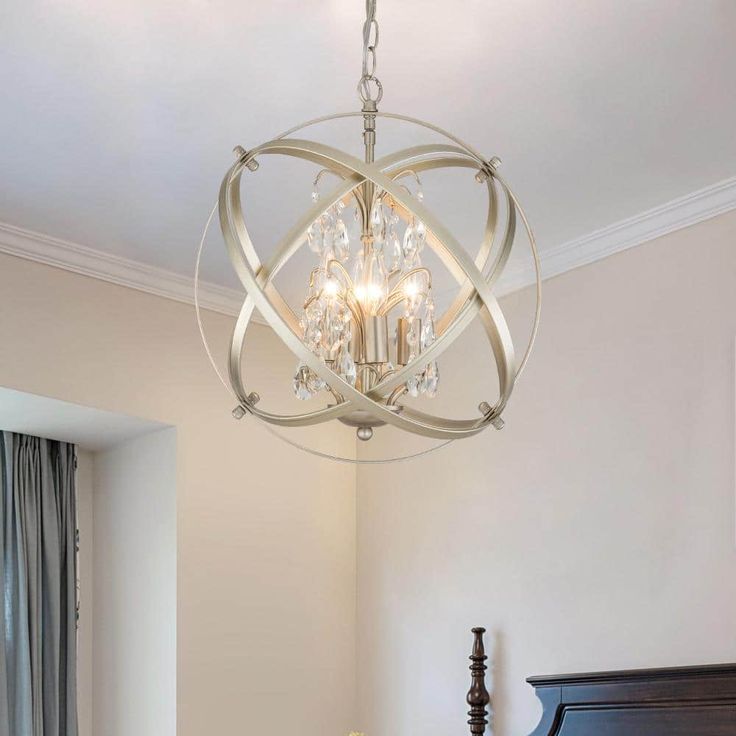 a chandelier hanging from the ceiling in a bedroom