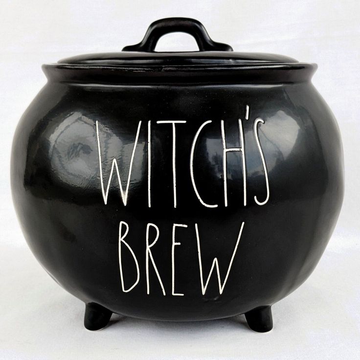 a black pot with the words witch's brew written in white ink on it