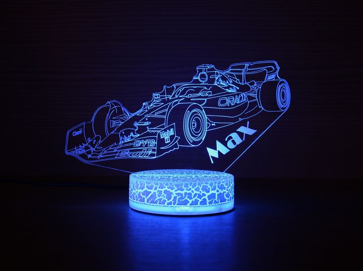 a lit up race car is shown in the dark