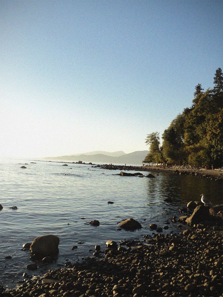 there are rocks on the shore of this lake