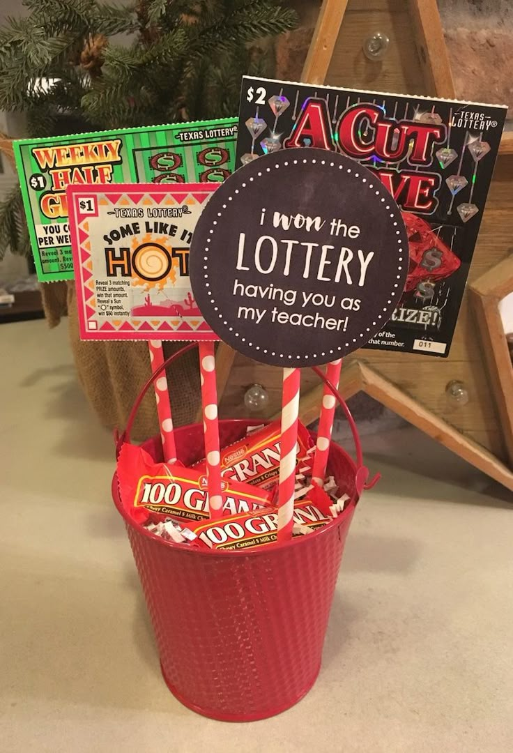 some candy bars in a bucket with a sign on the top that says i won the lottry having you as my teacher