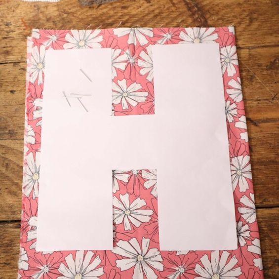 the letter h is made out of paper with flowers on it