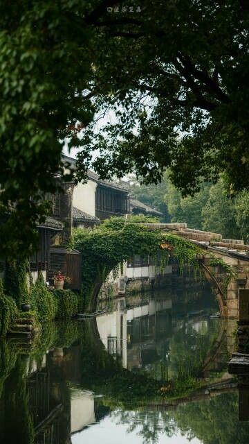 an old stone bridge over a small river