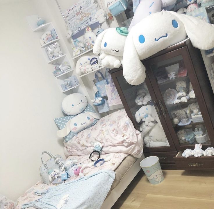 a room filled with lots of stuffed animals next to a baby's crib