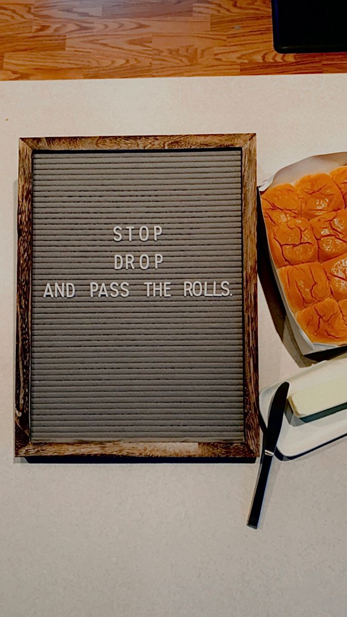 a sign that says stop drop and pass the rolls next to some other food items