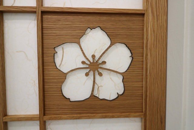 a wooden frame with a flower cut out of it