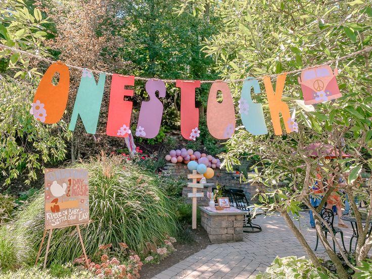 there is a sign that says one stop next to some plants and flowers in the yard