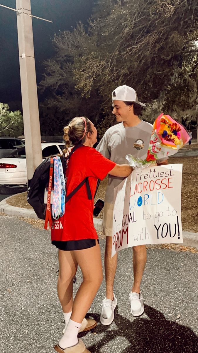 a man standing next to a woman on a skateboard holding a sign that says, please across the world