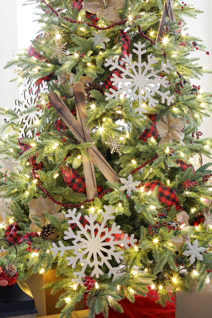 a christmas tree decorated with snowflakes and ribbons