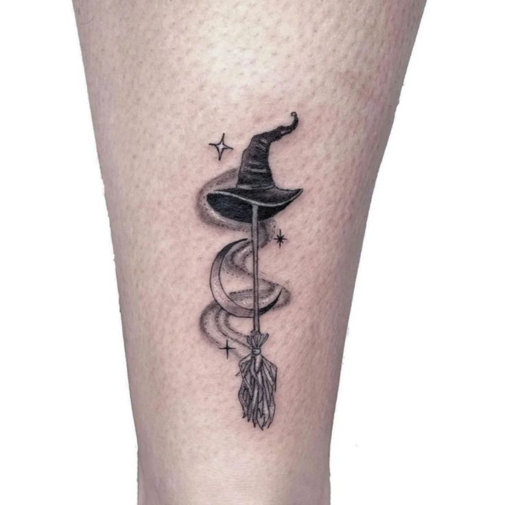 a black and white photo of a wizard's hat on the leg