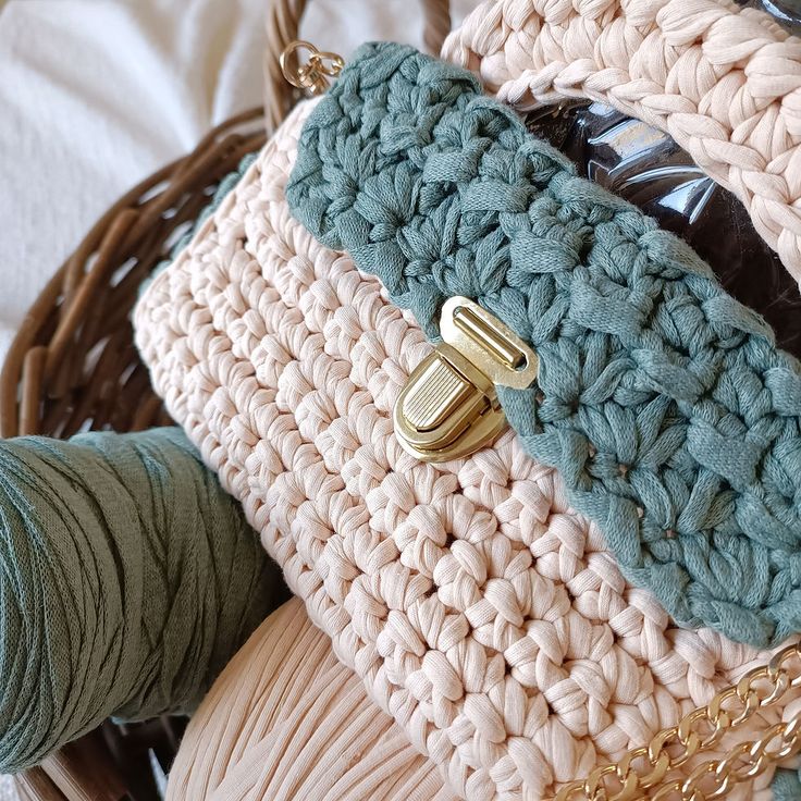 a close up of a basket with yarn and knitting needles