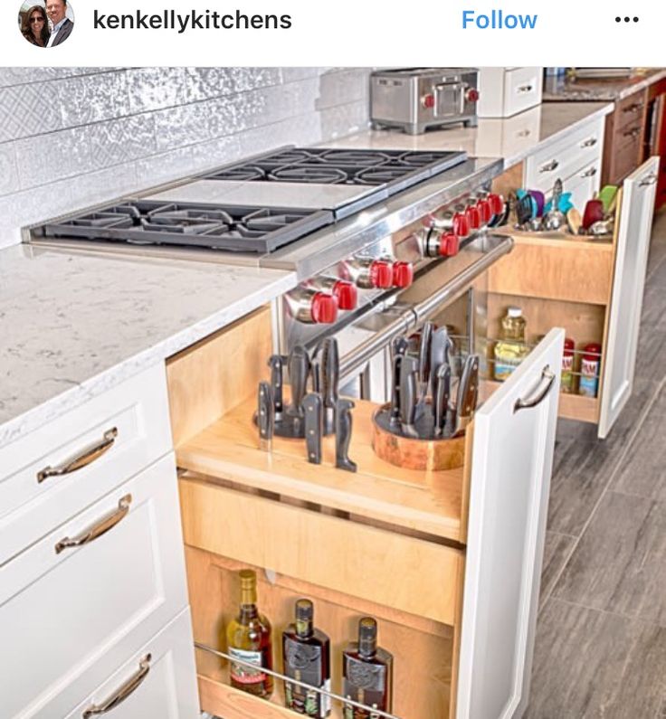 an open drawer in the middle of a kitchen with lots of spices and condiments