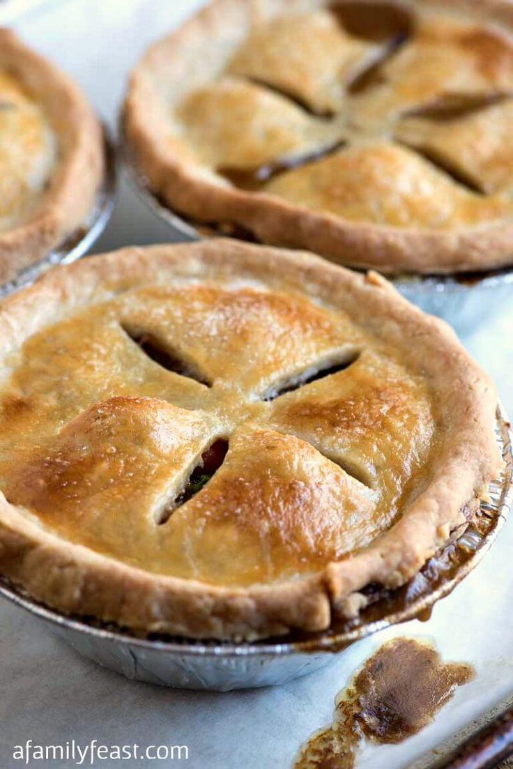 four pies sitting on top of a white tray