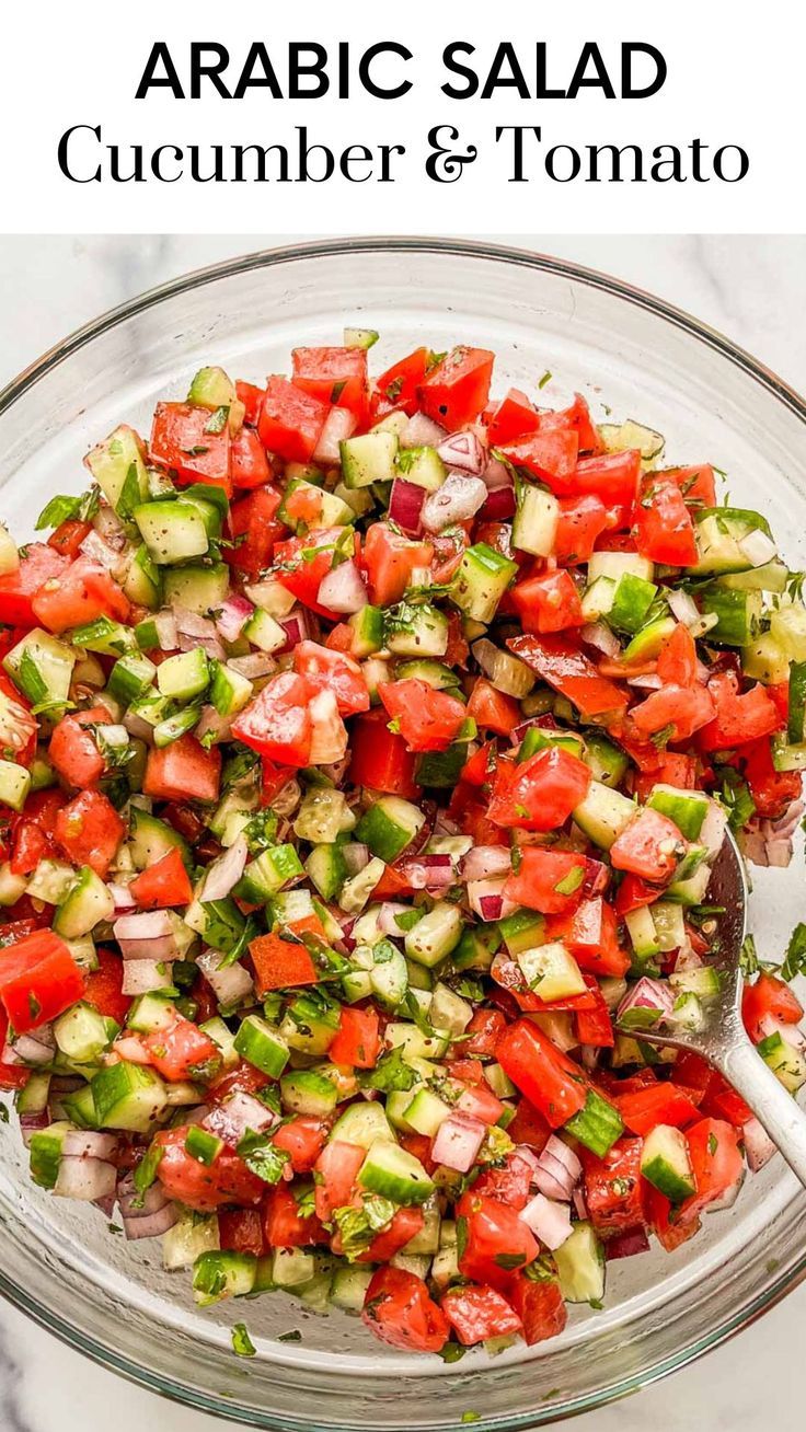 a glass bowl filled with cucumber and tomato salad