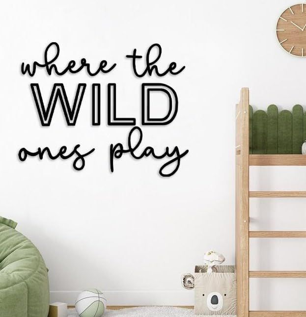 there is a wall sticker that says, where the wild ones play