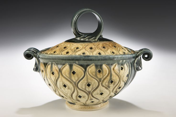 a ceramic vase with an ornate design on it