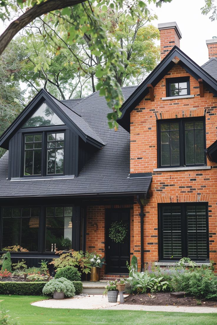 a brick house with black shutters and windows