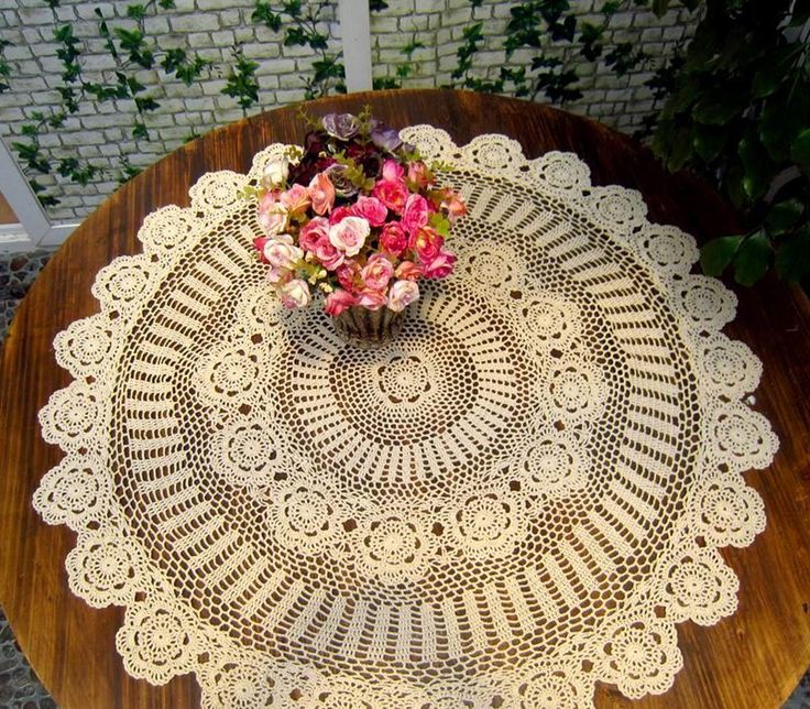 a doily on a table with flowers in it