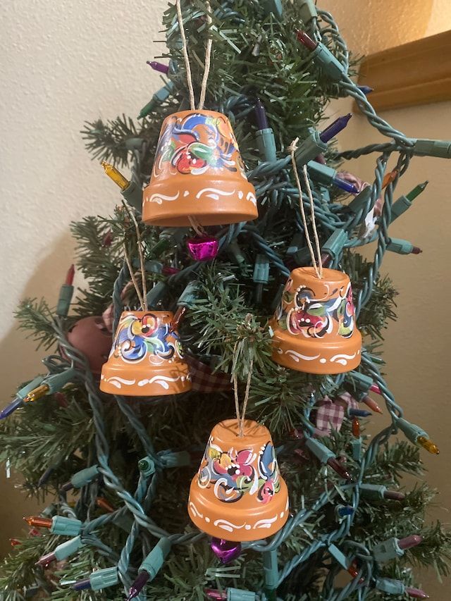 a christmas tree with ornaments hanging from it's branches in the shape of bells