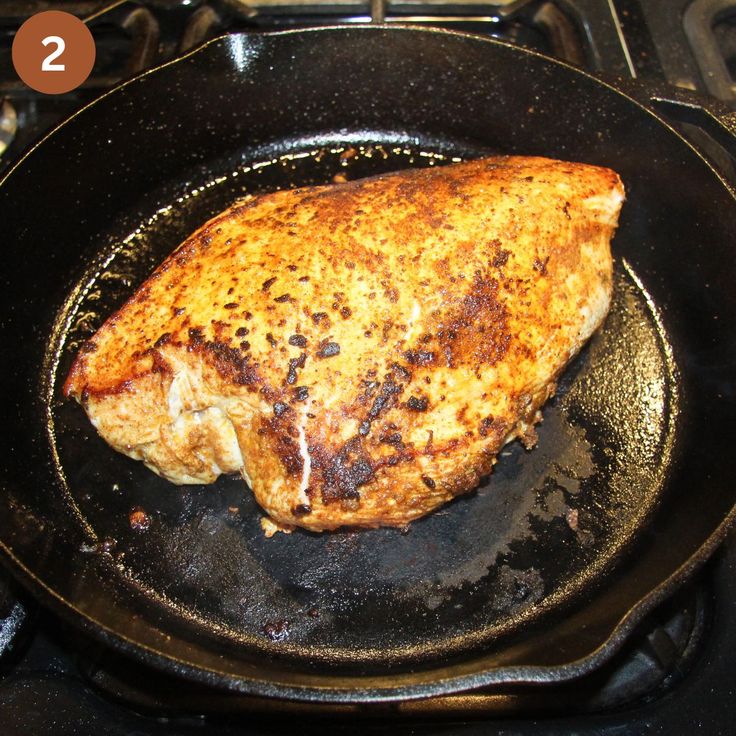 a piece of meat is cooking in a skillet