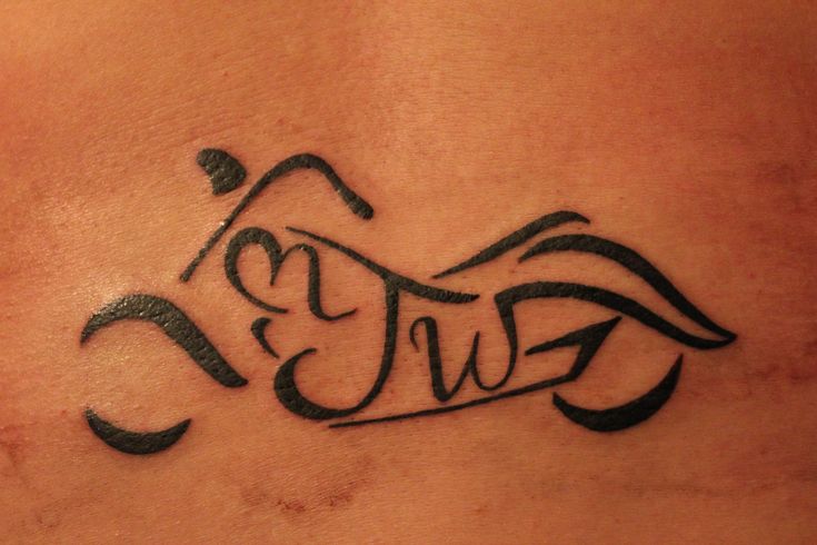 a close up of a tattoo on the back of a person's stomach,