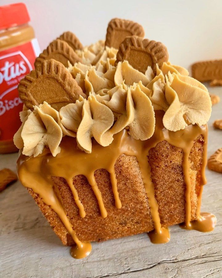 a close up of a cake on a table with peanut butter and cookies around it