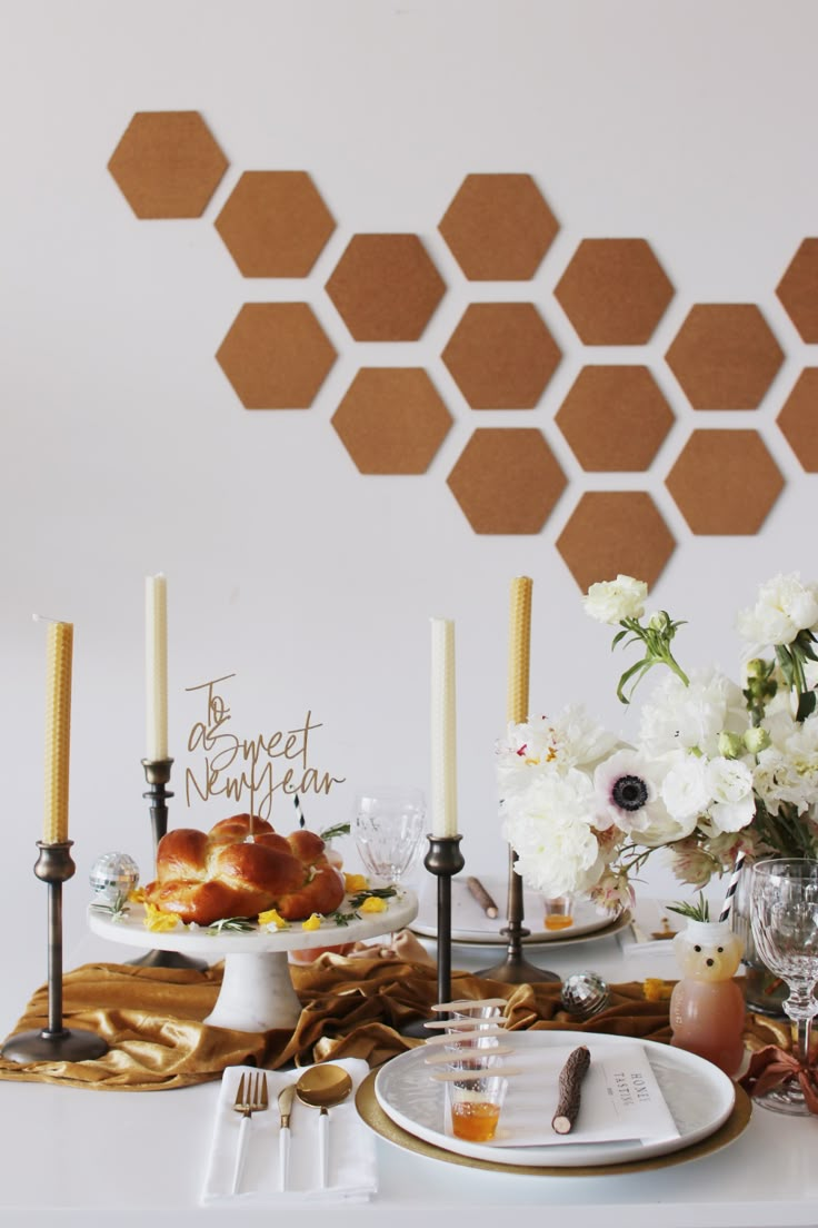 a white table topped with plates and candles