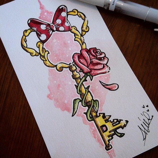 a drawing of a key with a rose on it next to a pen and paper