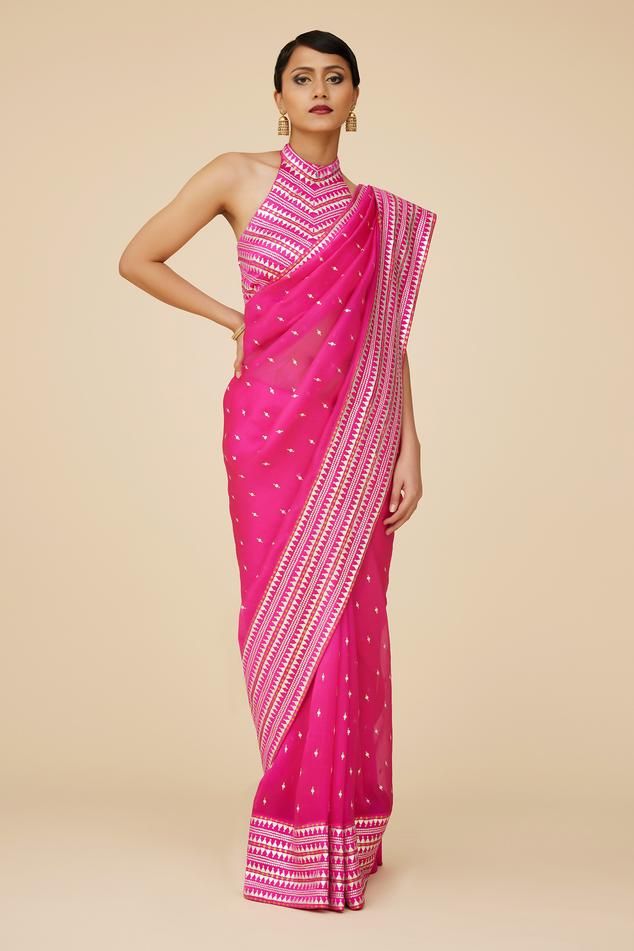 Fuchsia pink saree in silk organza base with all over prism pattern aari embroidery with sequins and zari. Paired with halter neck sleeveless blouse and a petticoat.
Components: 3
Pattern: Embroidery
Type Of Work: Aari Work With Sequins and Zari
Neckline: Halter Neck
Sleeve Type: Sleeveless
Fabric: Saree: Silk Organza, Blouse: Poly Satin, Petticoat: Poly Satin
Color: Pink
Other Details: 
Length:
Saree: 5.6-5.75inches
Petticoat: 39inches
Occasion: Wedding, Puja - Aza Fashions Pink Saree Silk, Prism Pattern, Organza Embroidery, Organza Blouse, Saree Silk, Embroidered Saree, Aari Embroidery, Pattern Embroidery, Indian Fashion Designers