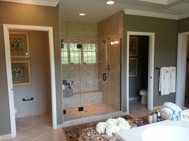 a bathroom with a walk in shower next to a sink and bathtub, along with other items on the floor