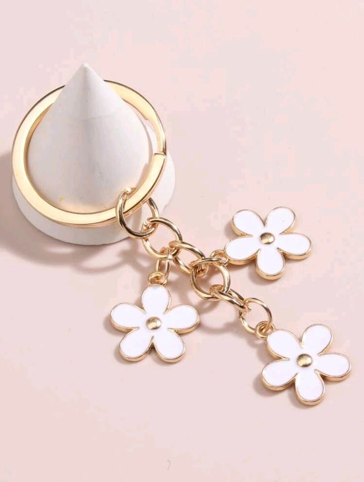 a close up of a key chain with flowers on it