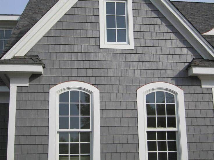 a gray house with white trim and windows