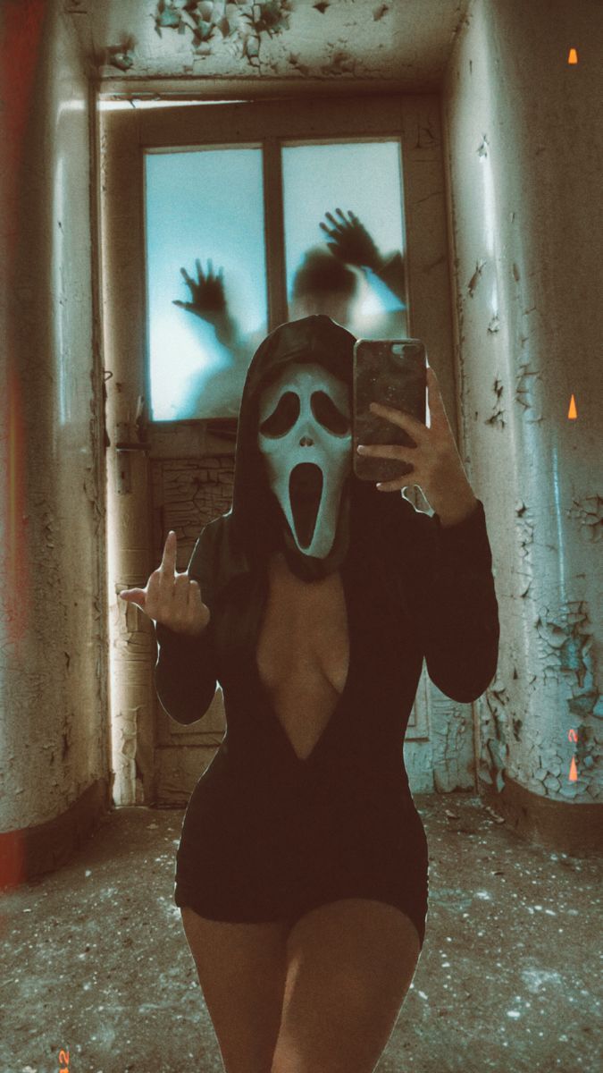 a woman wearing a mask taking a selfie