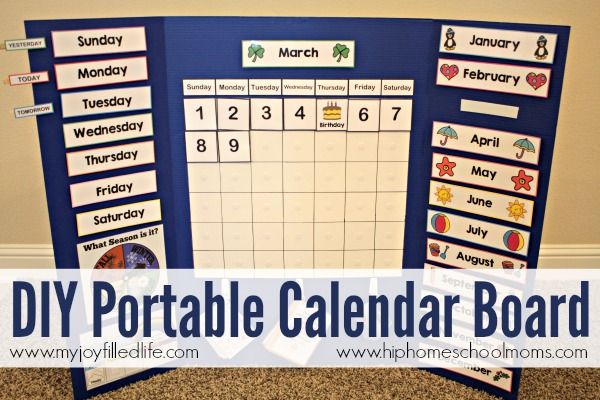 a blue bulletin board with calendars and magnets on it in front of a carpeted wall