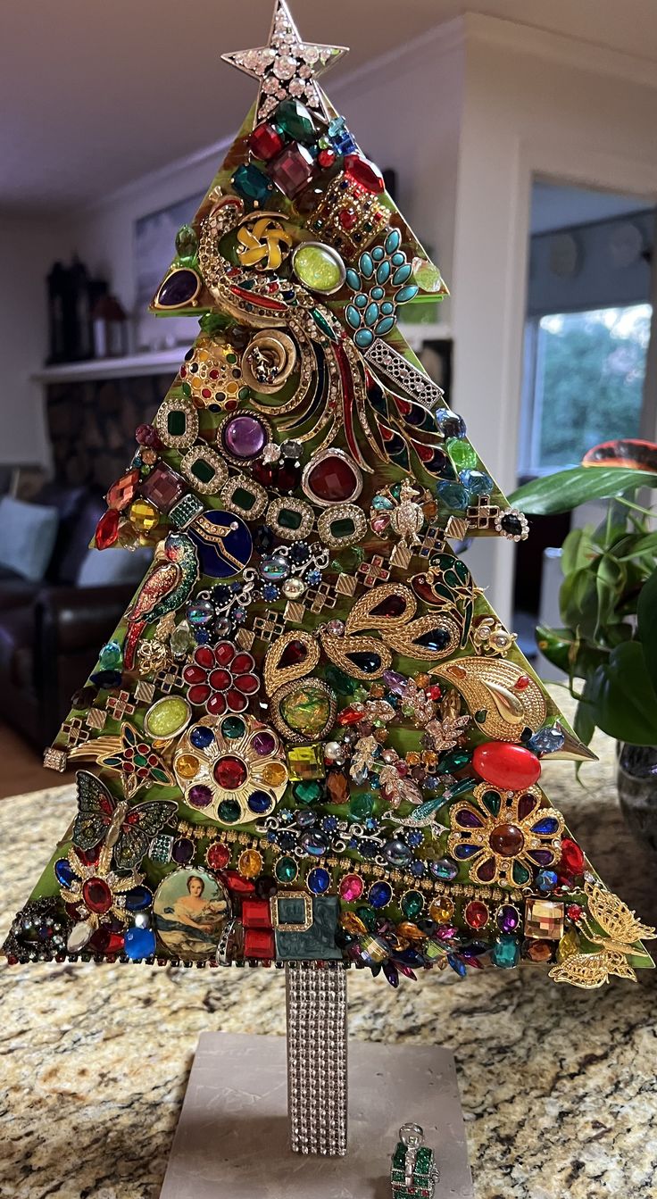 a christmas tree made out of jewelry on top of a counter