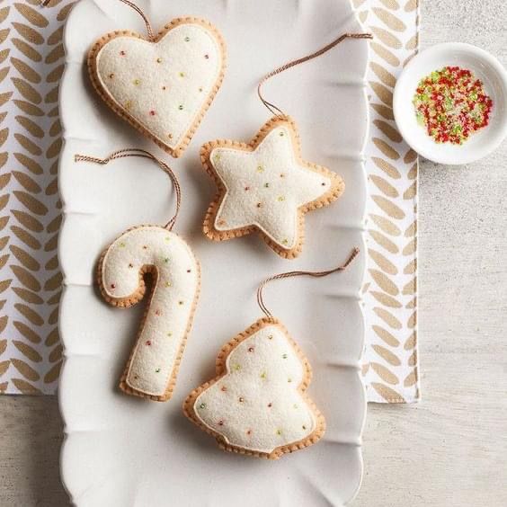 some cookies are on a white plate and one is shaped like a heart, the other has a star