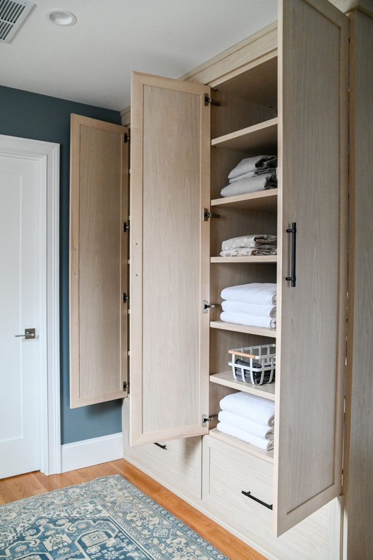 a closet with linens and towels in it