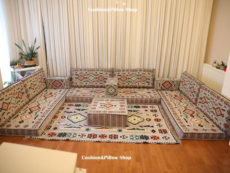 a living room with couches and rugs on the floor