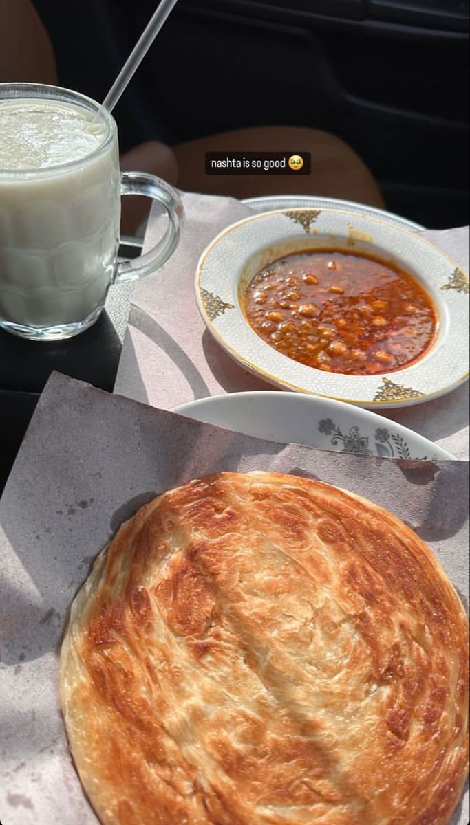 a table topped with a bowl of soup and a pie