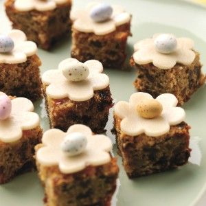 small cupcakes with white frosting on a plate