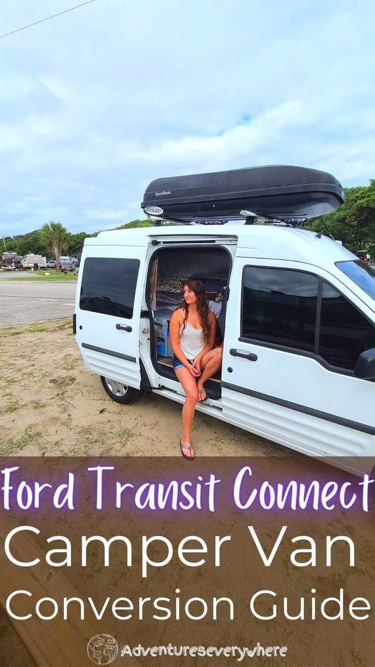 a woman sitting in the driver's seat of a camper van