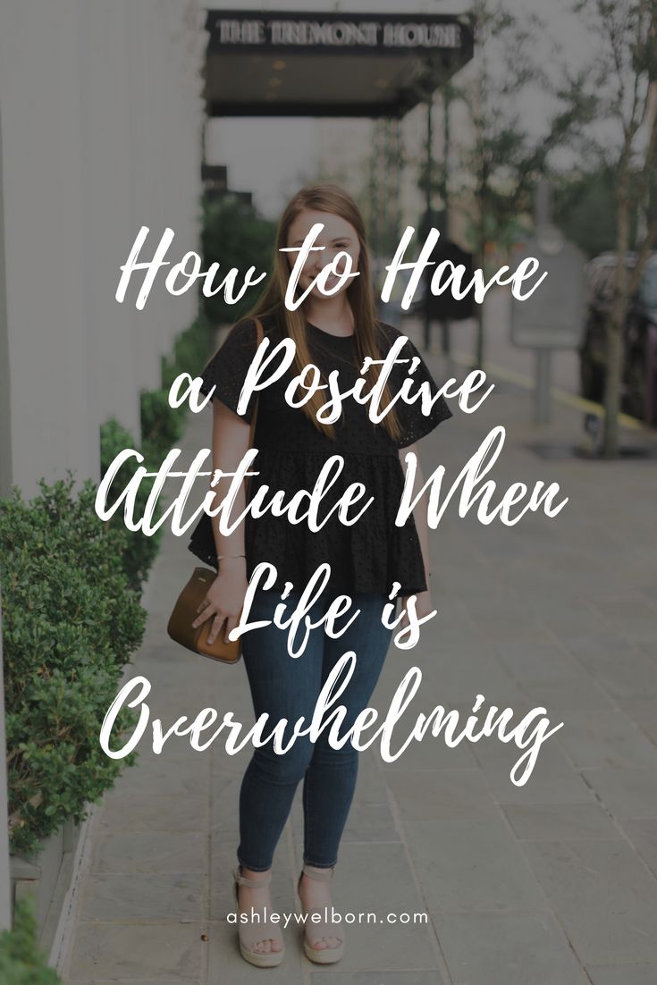 a woman standing in front of a building with the words how to have a positive attitude when