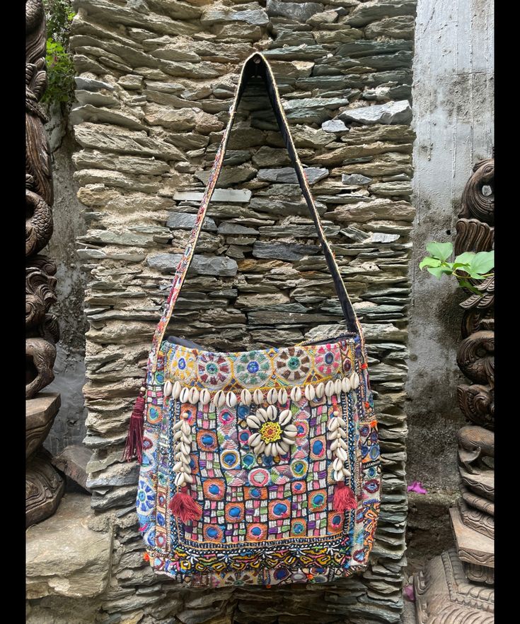 About bag  Indo-gypsy fusion, everyday use hand bag made from Banjara fabrics sourced from Vintage tribal costumes of regions of Rajastan and Gujarat. These are embellished with light catching coins, and intricate bead work tassels. Size - length 15 inches/ width 21 inches Company details:  Company name: Houseoftextile  Contact number: +919784447473  Email id: houseoftextile77@gmail.com  Shipping & custom : Delivery through one of the finest service providers : Skyway, Fedex, UPS  And DHL. Any l Handmade Multicolor Embroidered Festive Shoulder Bag, Festive Multicolor Embroidered Handmade Shoulder Bag, Festive Handmade Multicolor Embroidered Shoulder Bag, Festive Handmade Shoulder Bag With Multicolor Embroidery, Festive Handmade Embroidered Shoulder Bag, Multicolor Embroidery Shoulder Bag For Festivals, Multicolor Embroidered Handwork Shoulder Bag For Festivals, Navratri Shoulder Bag With Handwork, Festival Shoulder Bag With Multicolor Embroidery And Handwork