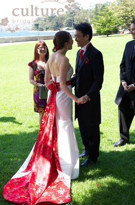 a man and woman standing next to each other in front of a sign that says culture bridal