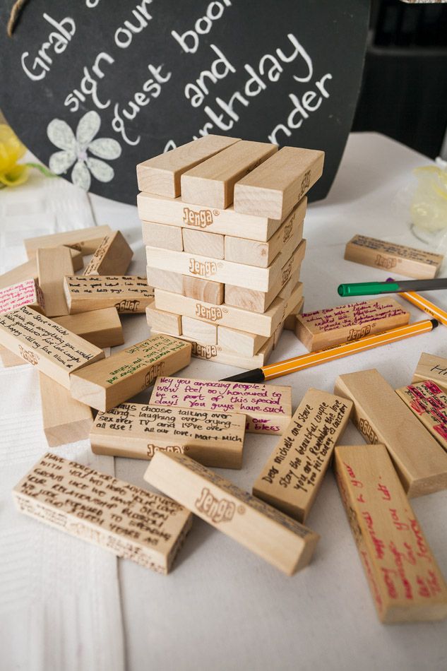 a pile of wooden blocks sitting on top of a table next to some pencils