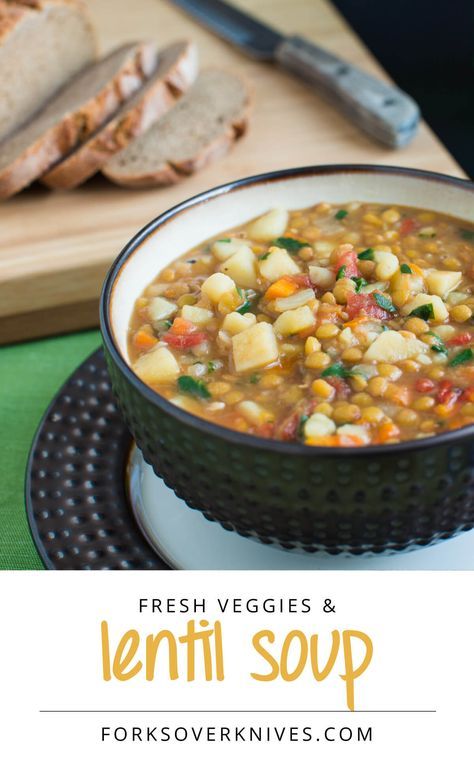 a bowl of soup with bread on the side