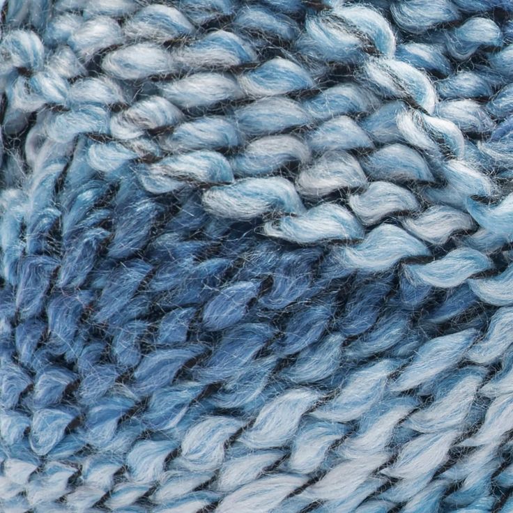 blue and white yarn textured together in an abstract pattern, close - up photo